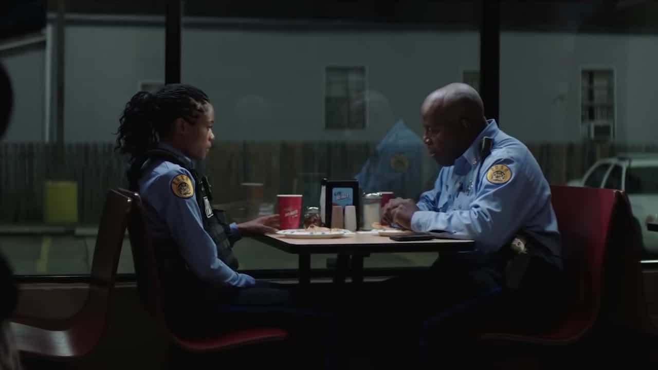 Naomie Harris and a fellow officer at a diner table in Black and Blue