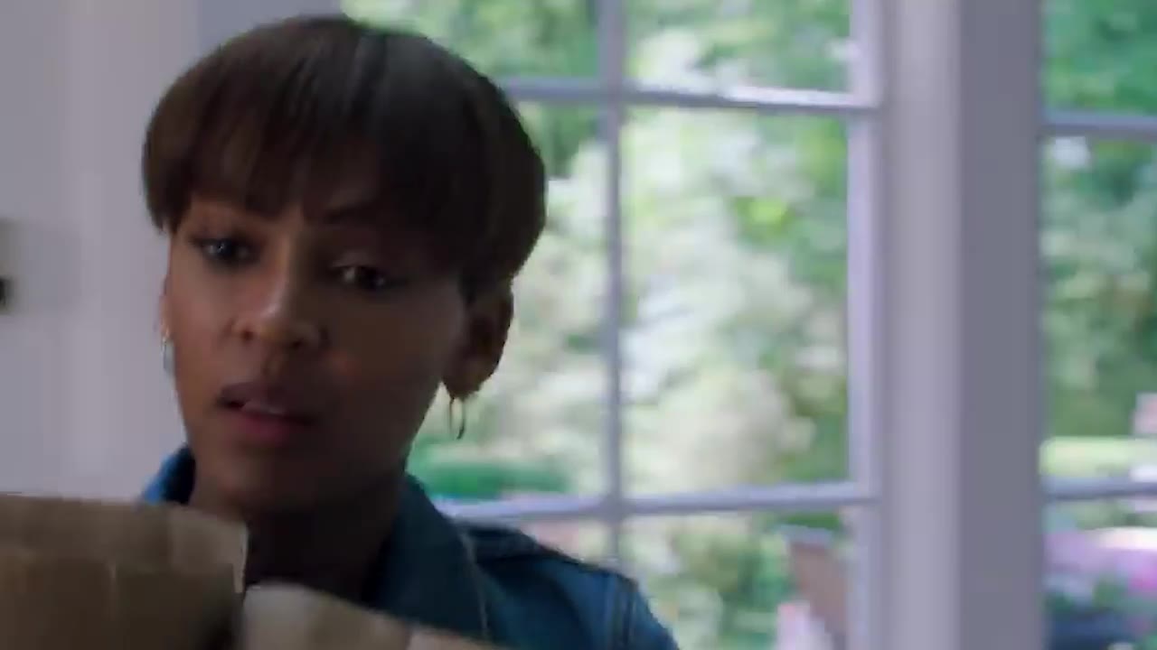 Meagan Good carrying a moving box in The Intruder